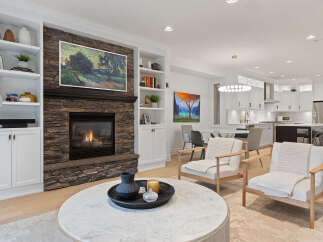 Experience modern living in this beautifully appointed home, featuring a stunning stone fireplace as the centerpiece of the living room.