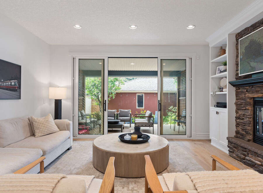 Experience seamless indoor-outdoor living with this stunning living room, featuring expansive sliding glass doors that open to a private patio.
