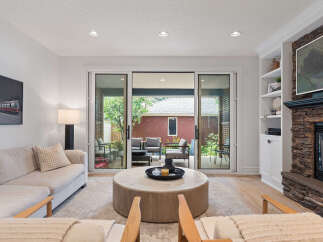 Experience seamless indoor-outdoor living with this stunning living room, featuring expansive sliding glass doors that open to a private patio.