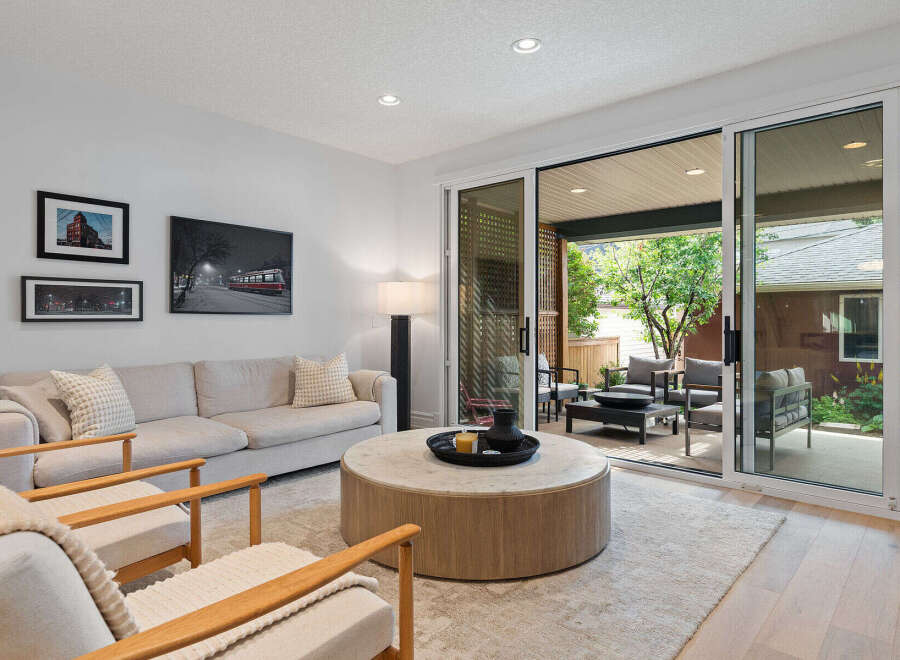 Step into this inviting living room, featuring a comfortable sofa and two accent chairs perfect for relaxation.