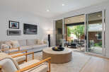 Step into this inviting living room, featuring a comfortable sofa and two accent chairs perfect for relaxation.