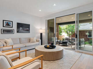 Step into this inviting living room, featuring a comfortable sofa and two accent chairs perfect for relaxation.