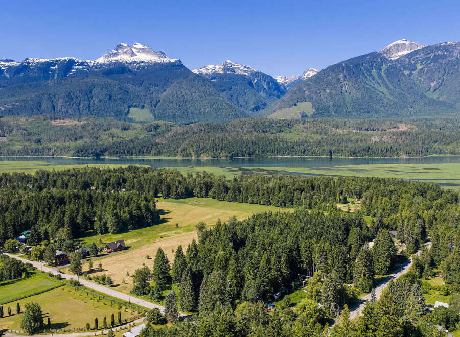 Discover your dream home nestled amidst breathtaking mountain scenery and a serene lake.