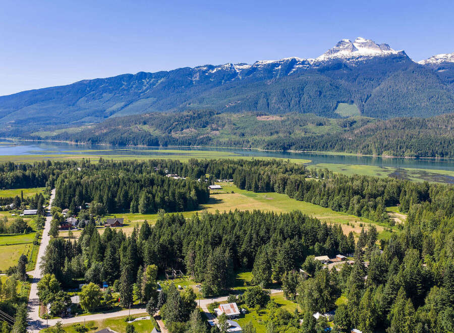 Discover serene living with this stunning aerial view of a property nestled amidst lush greenery and mature trees.