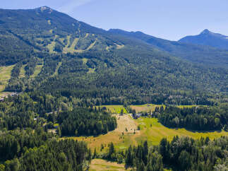 Discover this stunning property nestled amidst lush greenery and majestic mountains.