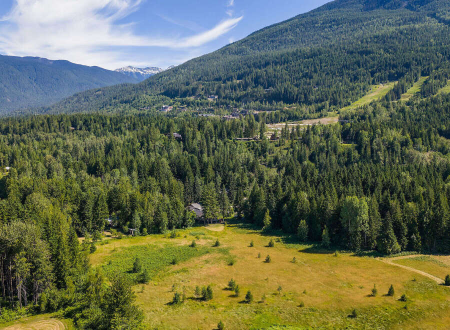 Nestled amidst a lush, evergreen forest, this property offers a serene escape with stunning mountain views.