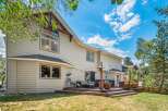 Enjoy outdoor living with this spacious deck featuring a sectional sofa, patio heater, and string lights, perfect for entertaining.