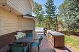 Enjoy outdoor living at its finest on this spacious deck, complete with a dining set, a built-in grill station, and a relaxing hot tub.