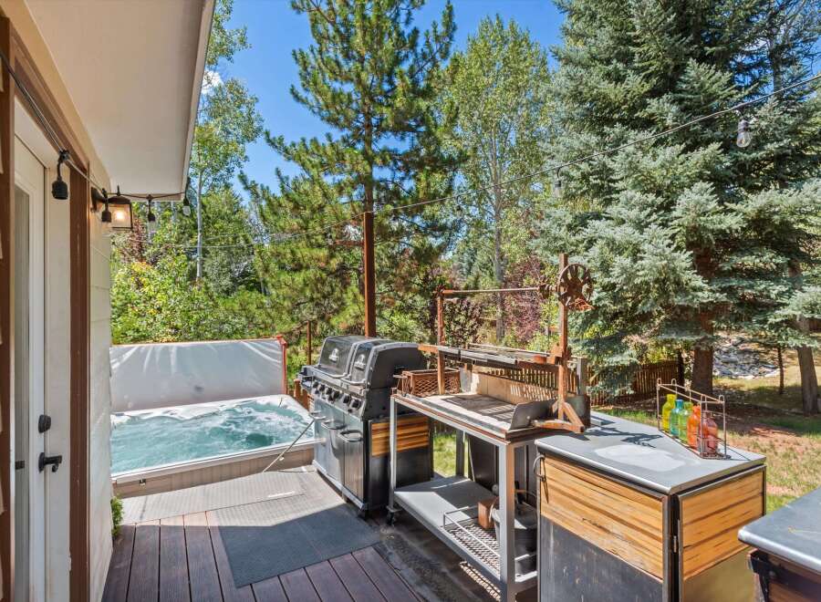 Enjoy ultimate relaxation and entertainment in this backyard oasis, featuring a bubbling hot tub perfect for unwinding and a spacious deck ideal for hosting.