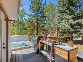 Enjoy ultimate relaxation and entertainment in this backyard oasis, featuring a bubbling hot tub perfect for unwinding and a spacious deck ideal for hosting.