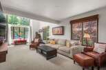 Experience the ultimate in relaxation and style in this inviting living room, featuring a spacious sectional sofa perfect for gatherings and plush leather armchairs for individual comfort.