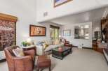 Experience ultimate comfort in this inviting living room, featuring plush leather armchairs and a spacious sectional sofa perfect for relaxation.