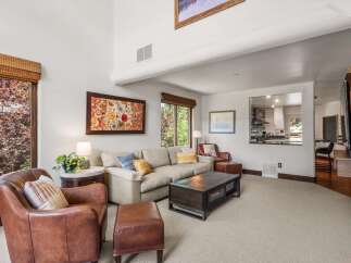 Experience ultimate comfort in this inviting living room, featuring plush leather armchairs and a spacious sectional sofa perfect for relaxation.