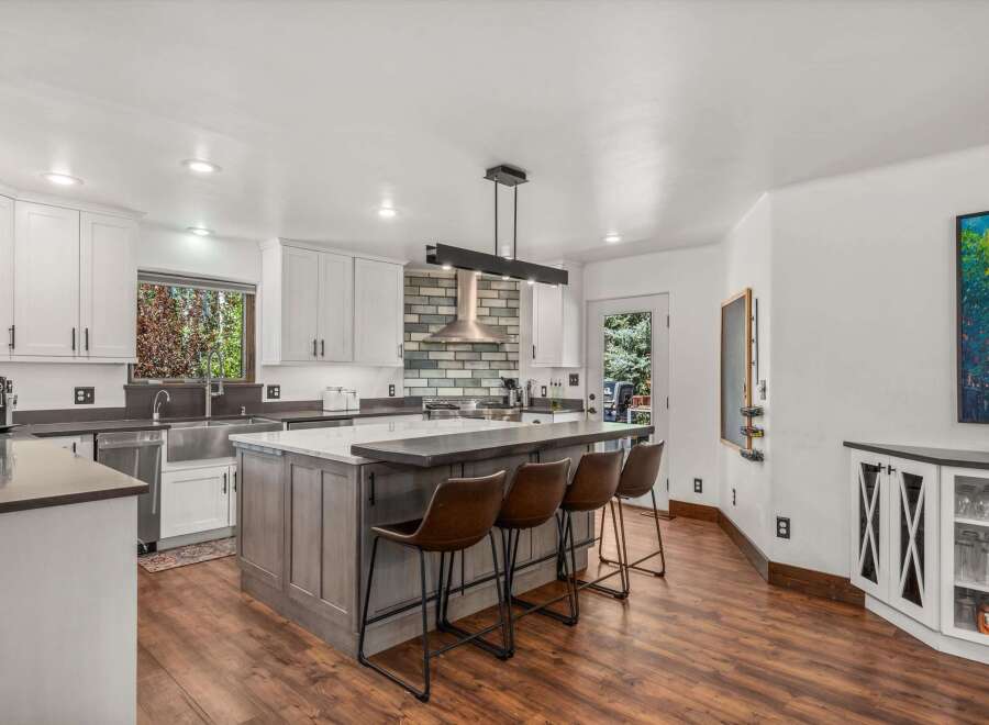Experience modern living in this stunning kitchen, featuring a large island with seating perfect for casual dining and entertaining.