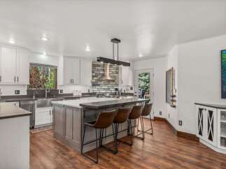 Experience modern living in this stunning kitchen, featuring a large island with seating perfect for casual dining and entertaining.