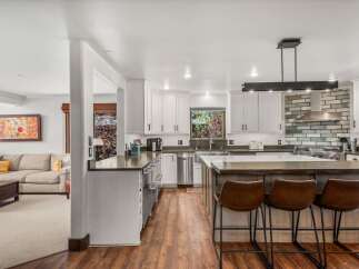 Experience the best of open-concept living with this stunning kitchen and adjacent living area.