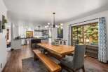 Experience seamless indoor-outdoor living in this beautifully appointed dining area, featuring a rustic wooden table and bench set perfect for gatherings.