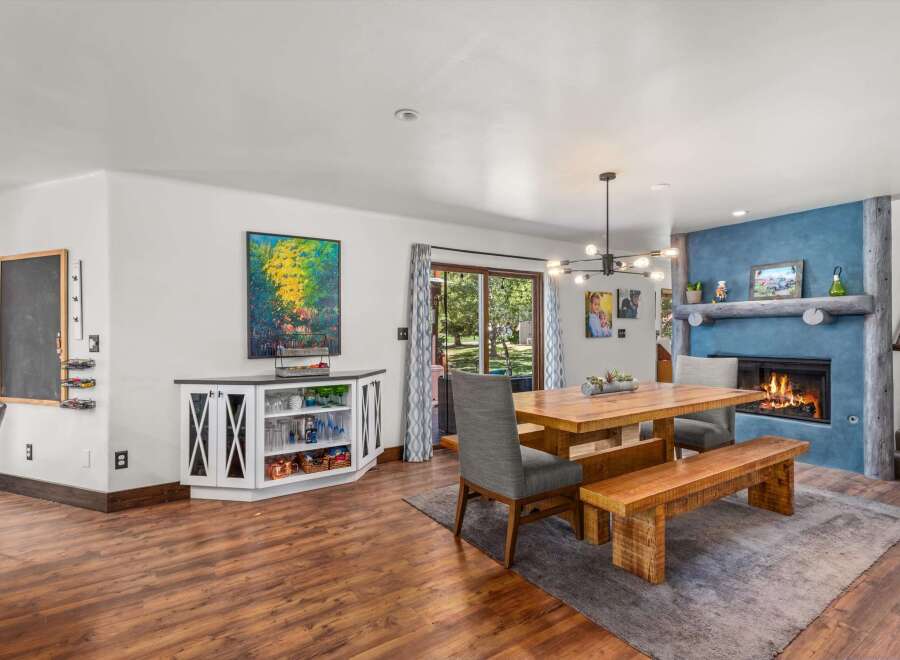 Experience cozy living in this inviting dining area, featuring a rustic wooden table and bench set perfect for family gatherings.