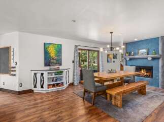 Experience cozy living in this inviting dining area, featuring a rustic wooden table and bench set perfect for family gatherings.