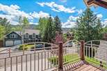 Enjoy stunning mountain views from this beautiful home, featuring a spacious deck with a white railing perfect for outdoor relaxation.