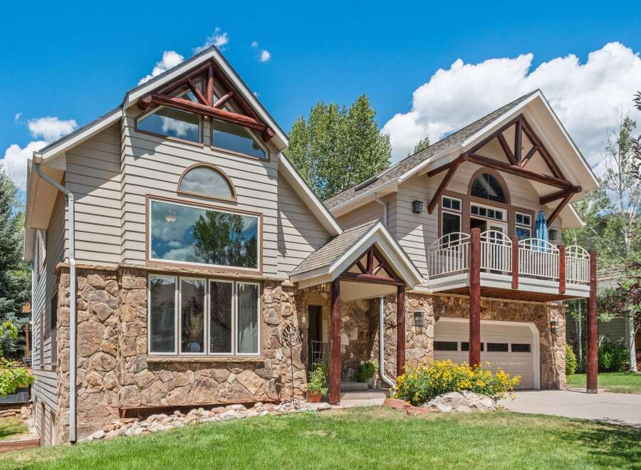 Experience mountain living in this stunning home featuring a unique blend of natural stone and siding.
