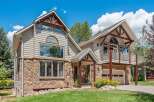 Experience mountain living in this stunning home featuring a unique blend of natural stone and siding.