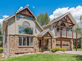 Experience mountain living in this stunning home featuring a unique blend of natural stone and siding.