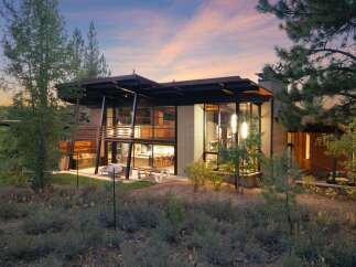 Experience modern luxury in this stunning architectural home, featuring expansive glass walls that blur the lines between indoor and outdoor living.