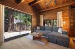 Experience rustic charm in this wood-paneled living room, featuring a spacious sectional sofa perfect for relaxation.
