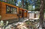Charming wooden cabin nestled amongst tall trees, offering a serene and rustic retreat.
