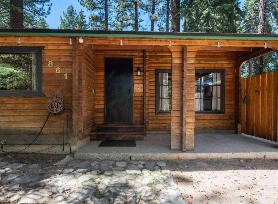 Charming log cabin exterior featuring a rustic wooden facade and a welcoming covered porch.