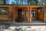 Charming log cabin exterior featuring a rustic wooden facade and a welcoming covered porch.