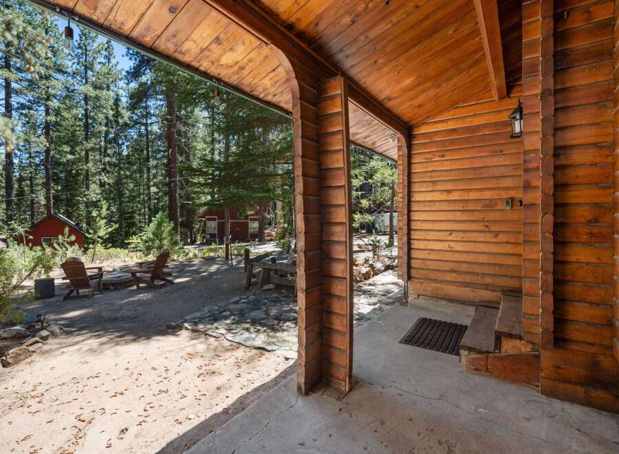 Experience rustic charm with this inviting cabin nestled amongst tall pine trees.
