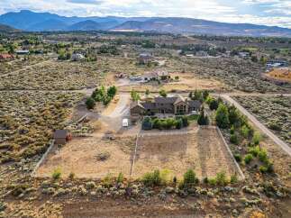 Discover this expansive estate featuring a luxurious home with stunning architectural details and ample living space.