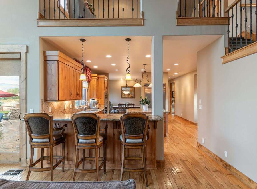 Experience luxury living in this stunning home featuring a gourmet kitchen with rich wood cabinetry and granite countertops, perfect for entertaining.