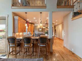 Experience luxury living in this stunning home featuring a gourmet kitchen with rich wood cabinetry and granite countertops, perfect for entertaining.
