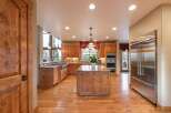 Experience luxury in this spacious kitchen featuring custom wood cabinetry and granite countertops.