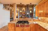 Experience rustic luxury in this stunning kitchen, featuring a professional-grade Wolf gas range and granite countertops.
