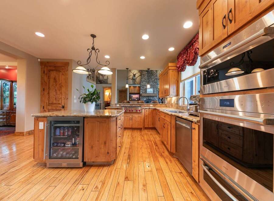 Experience luxury in this stunning kitchen featuring custom wood cabinetry and granite countertops.