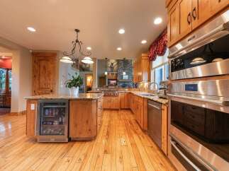 Experience luxury in this stunning kitchen featuring custom wood cabinetry and granite countertops.