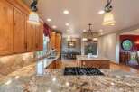Experience luxury in this spacious kitchen featuring custom wood cabinetry and stunning granite countertops.