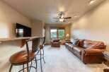 Experience ultimate relaxation in this inviting living space, featuring a plush leather sofa and a cozy armchair perfect for unwinding.