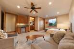 This spacious room offers a comfortable living area with a plush sofa and a unique coffee table, perfect for relaxation.