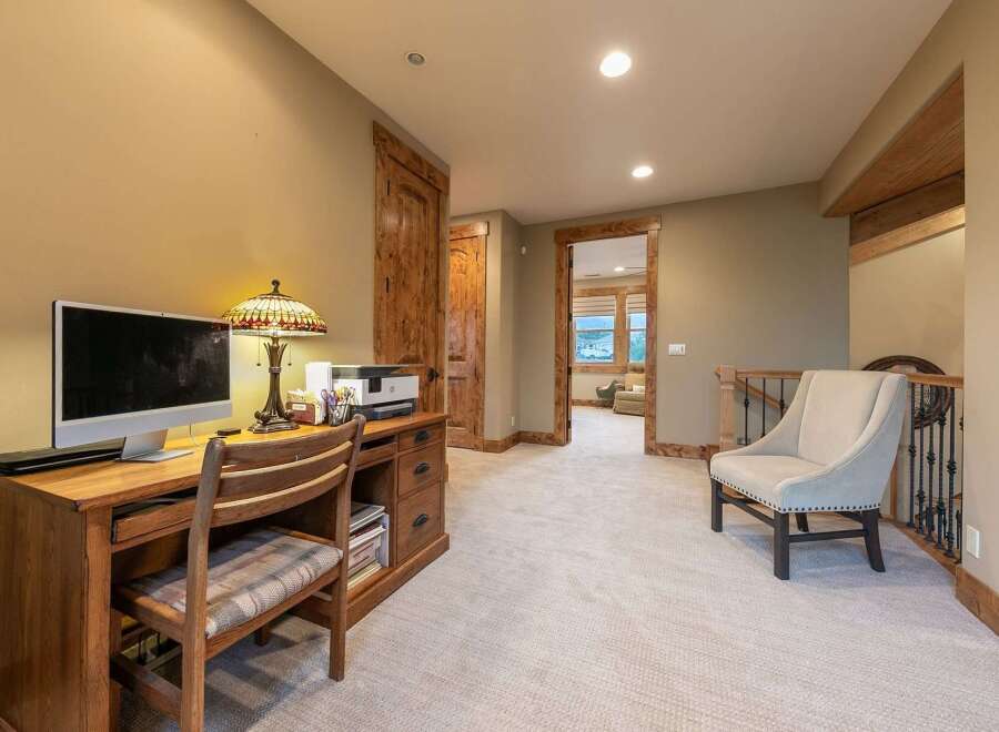 This spacious hallway features a dedicated home office area with a wooden desk, computer, and printer, perfect for remote work.
