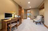 This spacious hallway features a dedicated home office area with a wooden desk, computer, and printer, perfect for remote work.