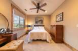 Experience comfort and style in this inviting bedroom, featuring a plush queen-size bed adorned with a quilted white comforter.