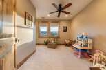 This charming room is perfect for children, featuring a dollhouse, toy table, and comfortable seating.