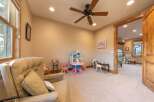 This charming room is perfect for children, featuring a delightful dollhouse, a miniature tea set, and a cozy armchair for relaxation.
