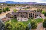 Experience luxury living in this expansive estate, featuring a stunning stone-accented facade and a sprawling backyard perfect for entertaining.