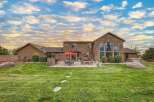 Experience luxurious outdoor living with this stunning backyard featuring a spacious patio, a built-in grill, and a cozy fire pit perfect for entertaining.